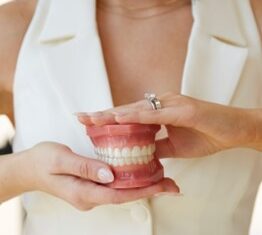 Person holding dental model with teeth
