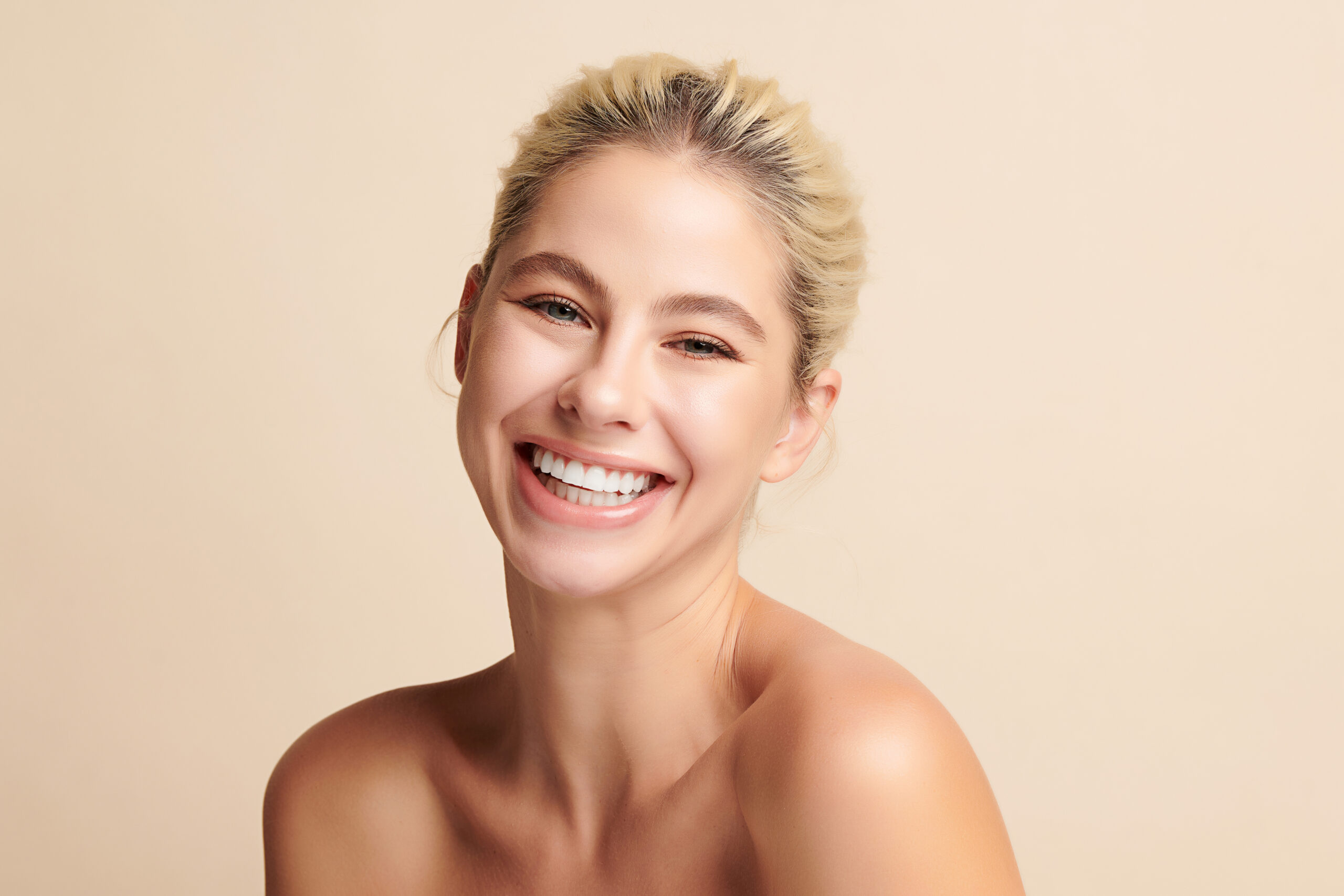 Beautiful smile young woman. White teeth on white background,