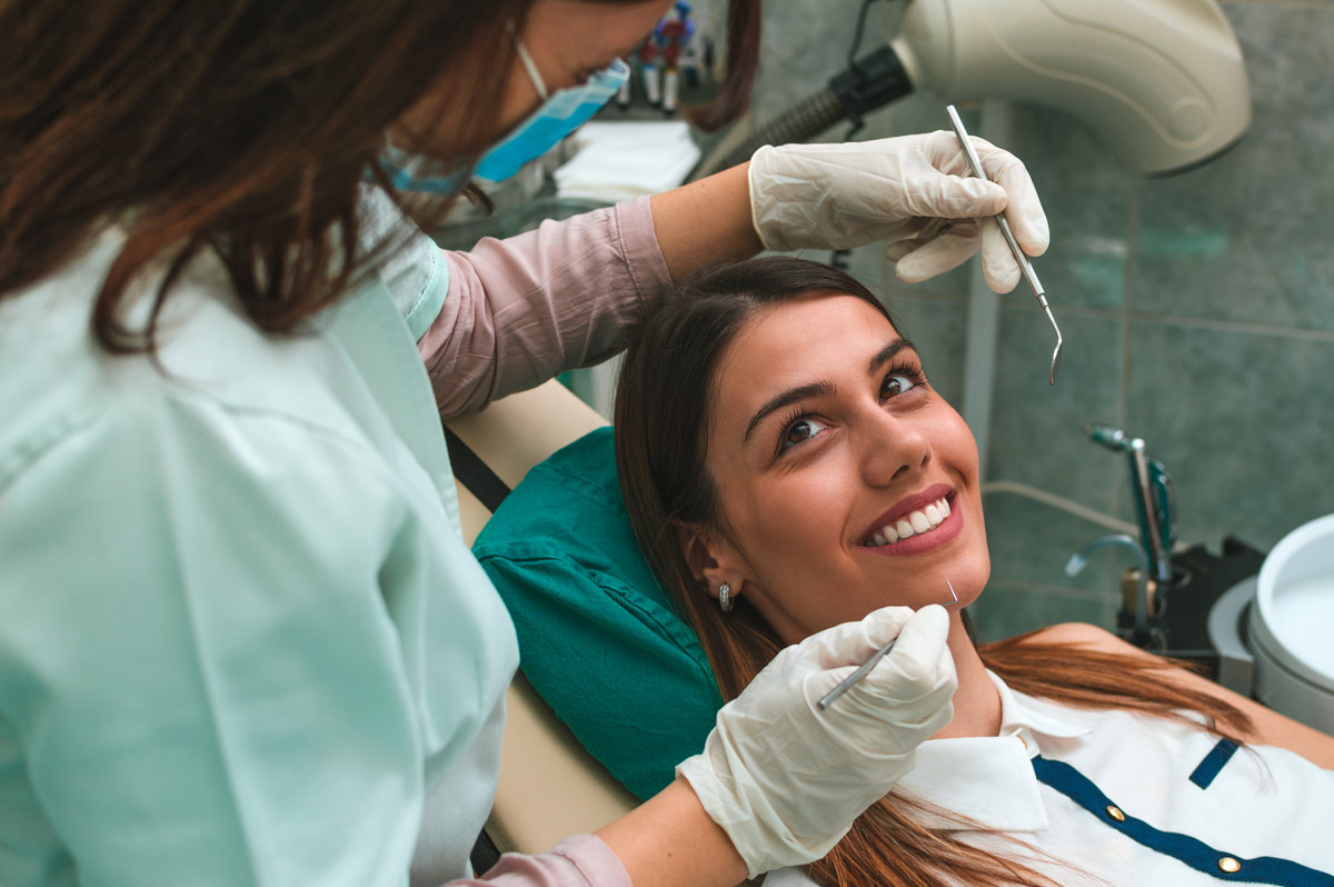 Gorgeous woman patient having dental treatment at dentist's office