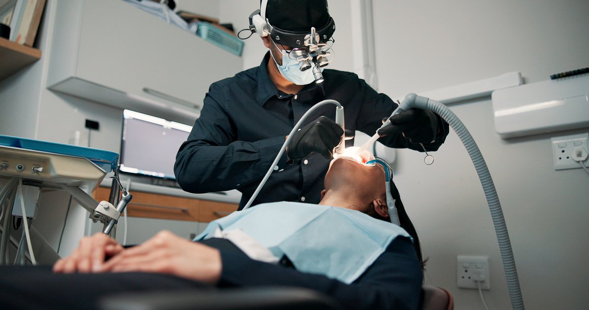 Checkup, medical procedure and patient with dentist in office for appointment or mouth operation. Dentistry, healthcare or oral exam with medicine professional and woman at clinic for dental hygiene.